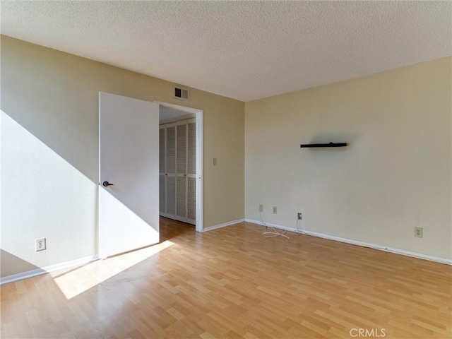 1923 Molino Ave Unit 303, Signal Hill, CA 90755 - unfurnished room with light wood-style flooring, a textured ceiling, and baseboards