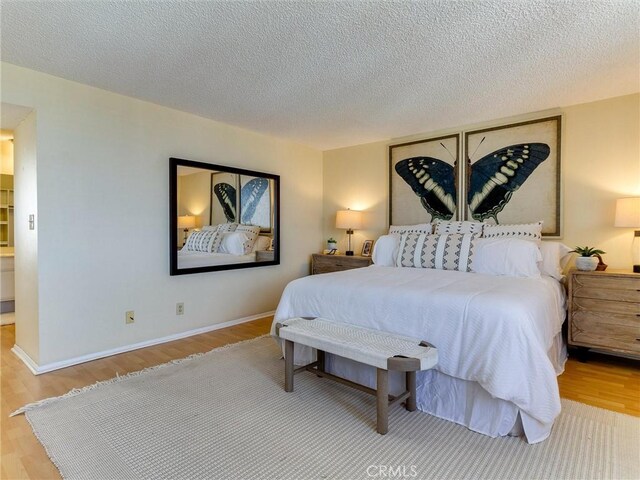 1923 Molino Ave Unit 303, Signal Hill, CA 90755 - bedroom featuring wood finished floors, a textured ceiling, and baseboards