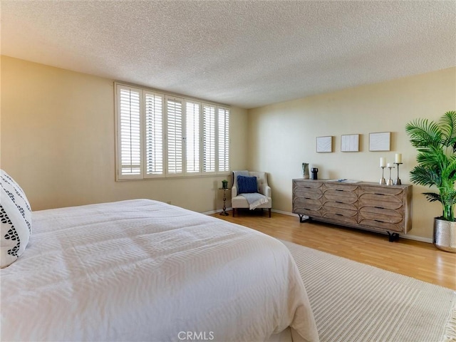 1923 Molino Ave Unit 303, Signal Hill, CA 90755 - bedroom with wood finished floors, a textured ceiling, and baseboards