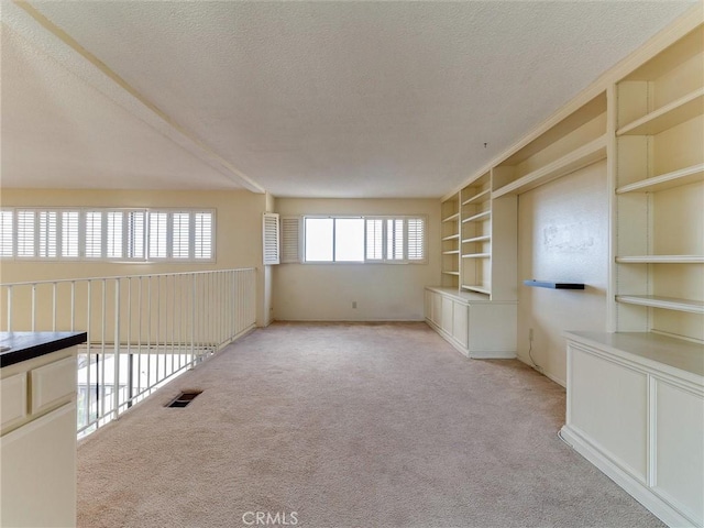 1923 Molino Ave Unit 303, Signal Hill, CA 90755 - unfurnished room with a textured ceiling, carpet floors, and built in shelves