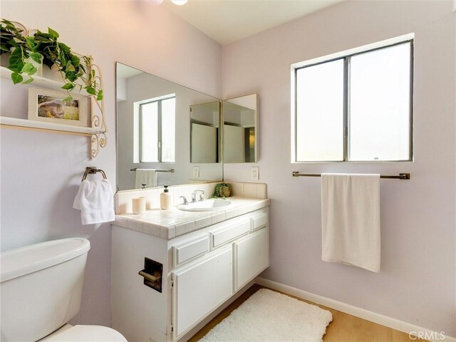 1923 Molino Ave Unit 303, Signal Hill, CA 90755 - bathroom with toilet, vanity, and baseboards