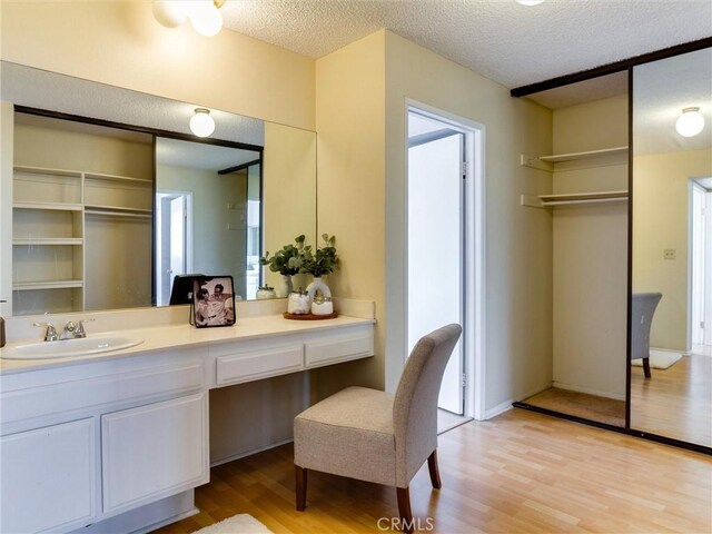 1923 Molino Ave Unit 303, Signal Hill, CA 90755 - bathroom featuring wood finished floors, a textured ceiling, and vanity