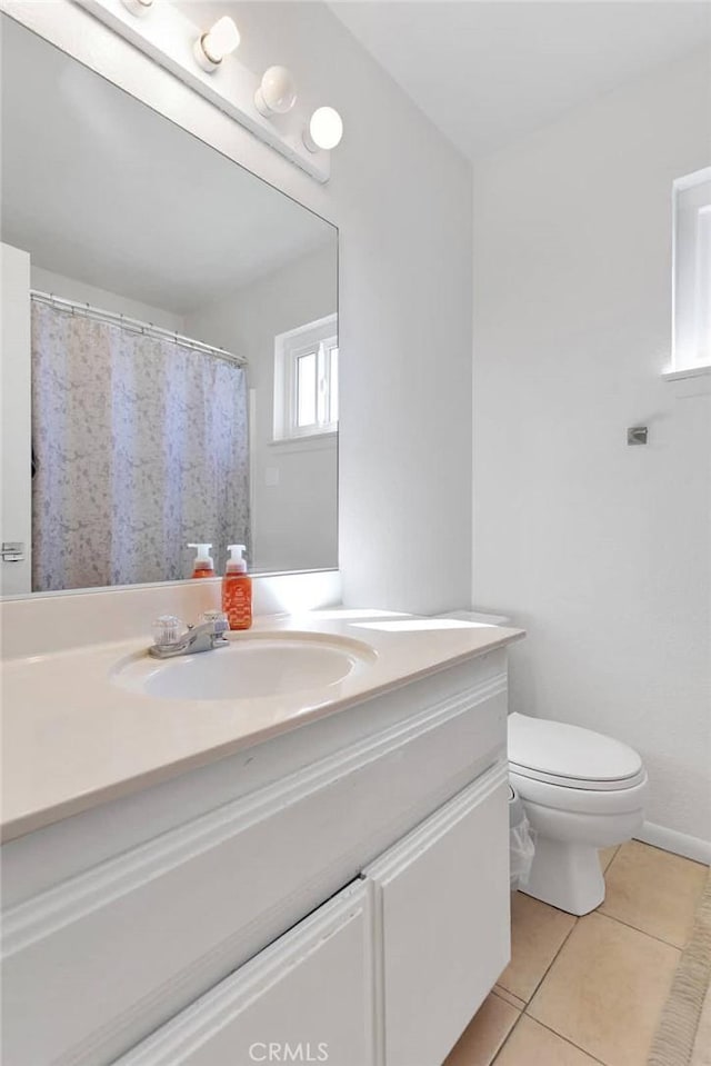 bathroom with vanity, tile patterned floors, and toilet