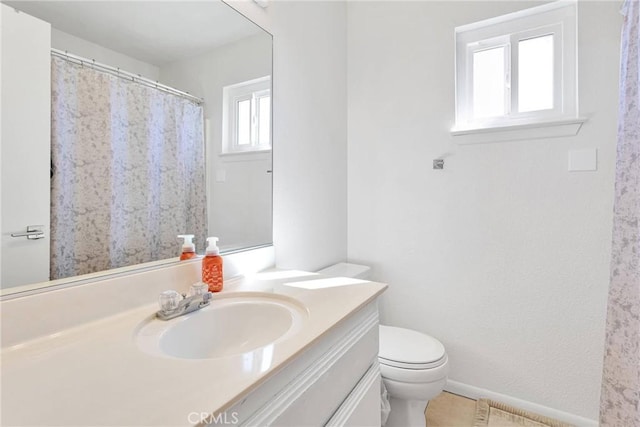 bathroom featuring tile patterned floors, vanity, and toilet