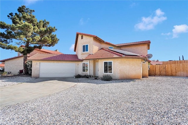 mediterranean / spanish house with a garage