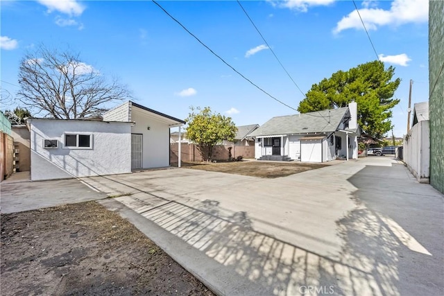 rear view of house featuring a garage