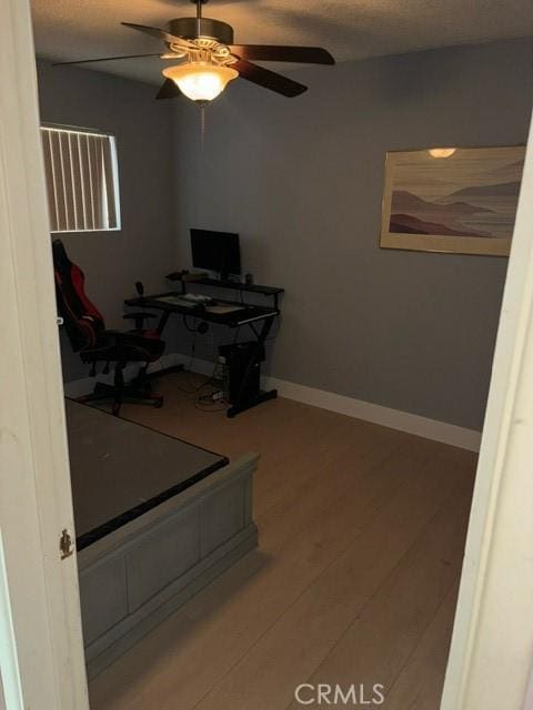 office area with hardwood / wood-style floors, a textured ceiling, and ceiling fan