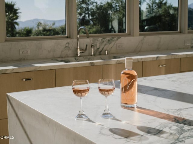 kitchen featuring a mountain view, sink, and decorative backsplash