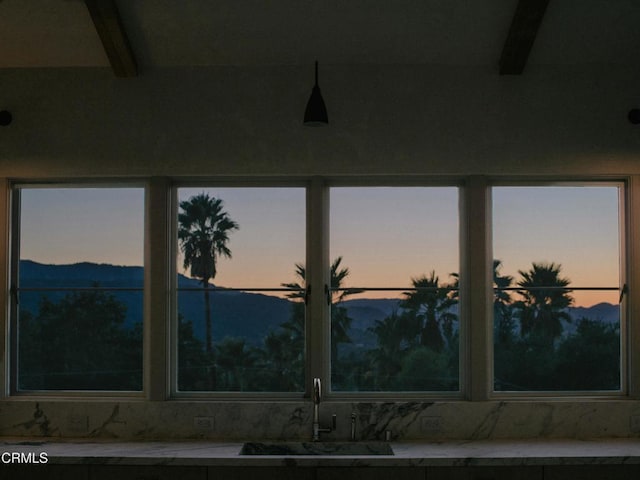 details with beam ceiling, a mountain view, and sink