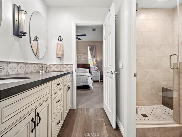 bathroom with vanity, wood-type flooring, and walk in shower