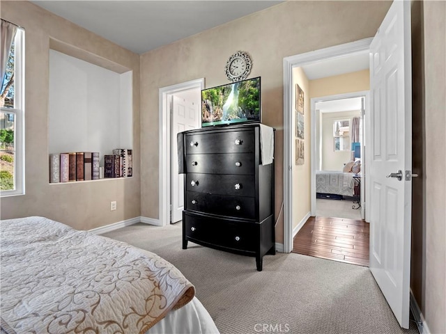 bedroom featuring light carpet