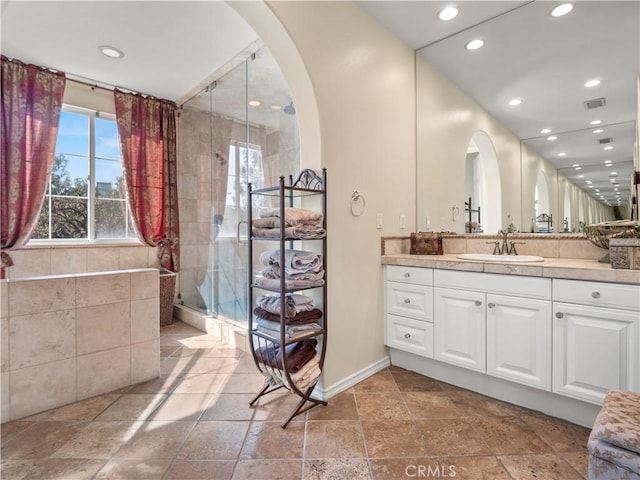 bathroom with vanity and a shower with shower door