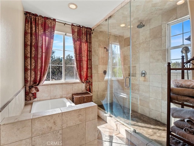 bathroom with separate shower and tub