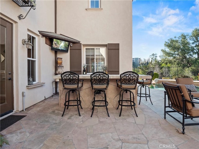 view of patio featuring an outdoor bar