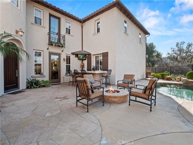 view of patio / terrace with a fenced in pool and an outdoor fire pit