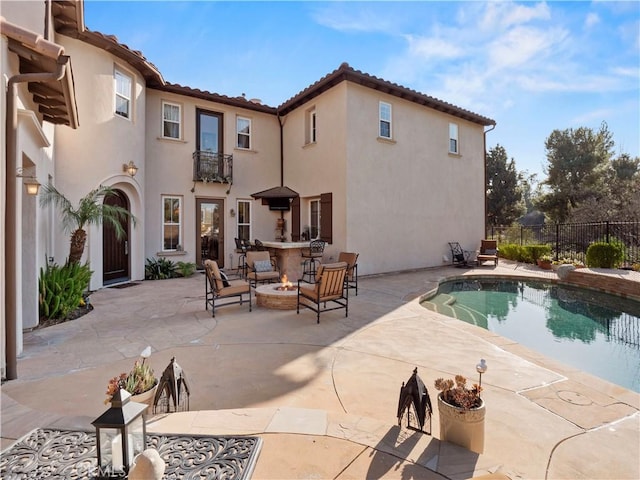 view of pool with a fire pit and a patio area