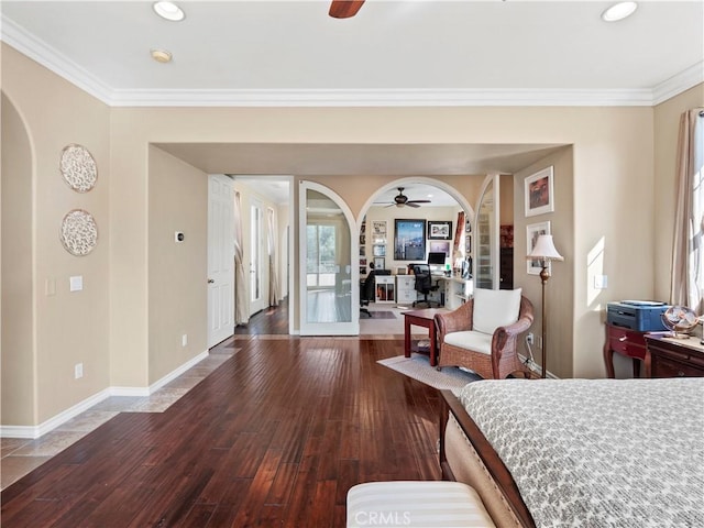 interior space featuring hardwood / wood-style floors, ornamental molding, and ceiling fan