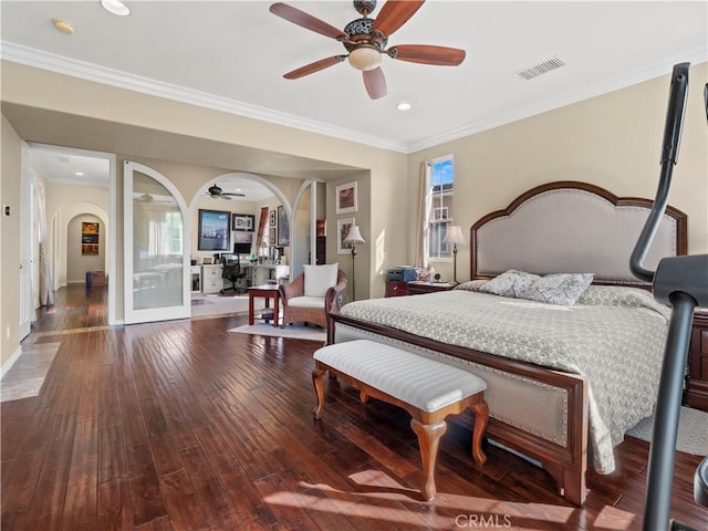 bedroom featuring hardwood / wood-style flooring, ornamental molding, ceiling fan, and multiple windows