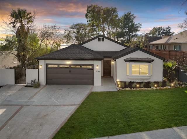 view of front of house featuring a garage and a lawn