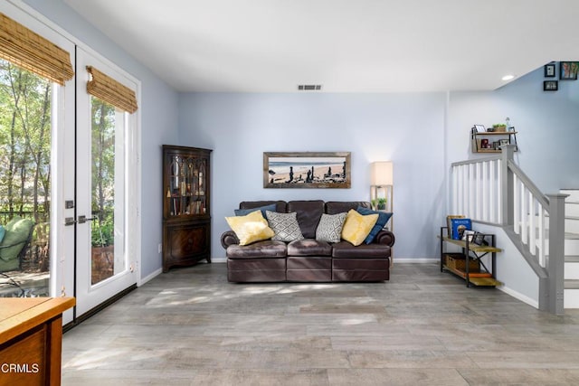 living room with light wood-type flooring and french doors