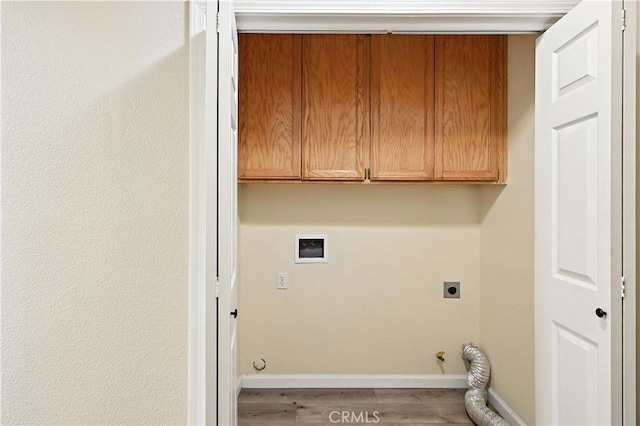 713 Vista Del Rey Dr, Atwater, CA 95301 - laundry room featuring cabinet space, wood finished floors, gas dryer hookup, and hookup for an electric dryer