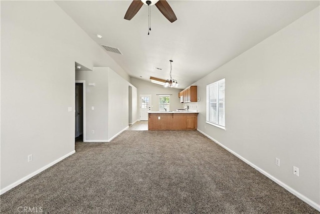 713 Vista Del Rey Dr, Atwater, CA 95301 - unfurnished living room with vaulted ceiling, carpet, ceiling fan, and a chandelier