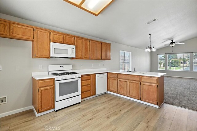 713 Vista Del Rey Dr, Atwater, CA 95301 - kitchen featuring a peninsula, white appliances, light countertops, vaulted ceiling, and light wood finished floors