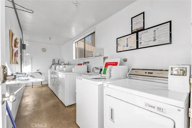 clothes washing area featuring washer and dryer