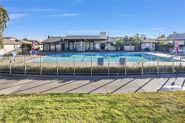 view of pool featuring a lawn