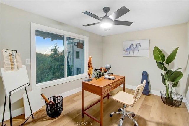 office featuring ceiling fan, wood finished floors, and baseboards