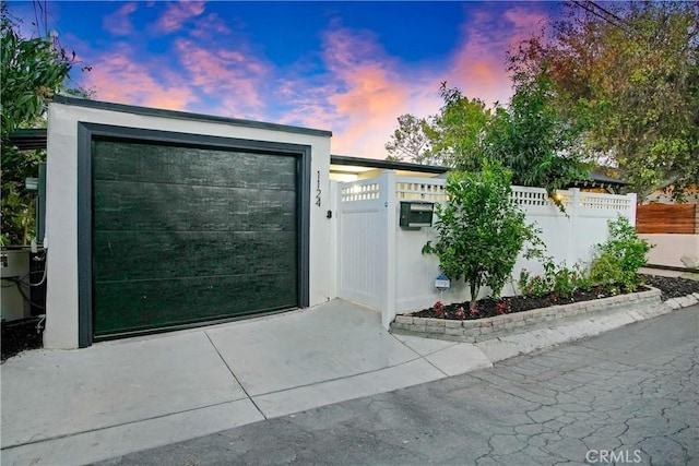 view of front facade with driveway and fence