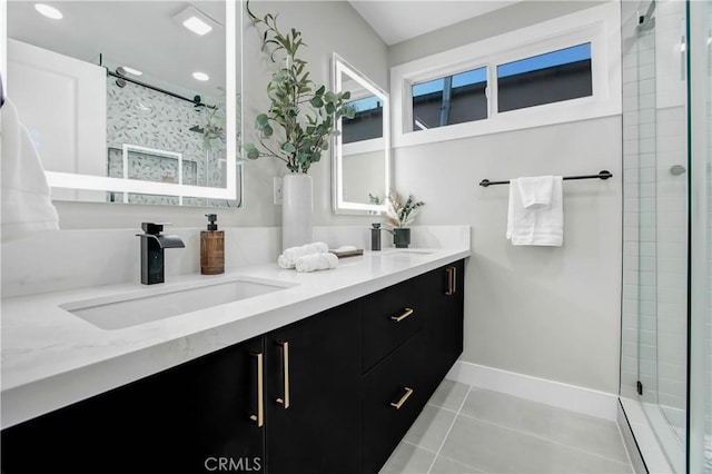 full bathroom featuring double vanity, baseboards, tile patterned flooring, a shower stall, and a sink