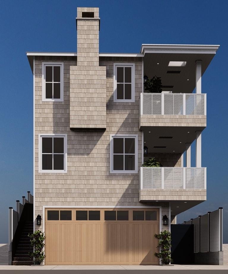 view of front facade featuring a balcony and a garage