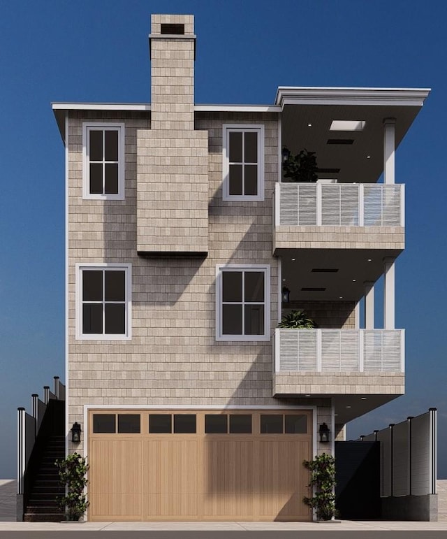 view of front facade featuring a balcony and a garage