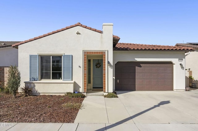 mediterranean / spanish-style home with a garage