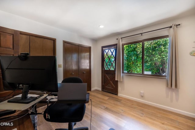 office space with recessed lighting, light wood-style flooring, and baseboards