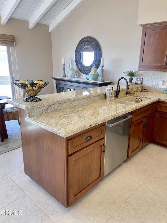 kitchen with dishwasher, a peninsula, light stone counters, and a sink