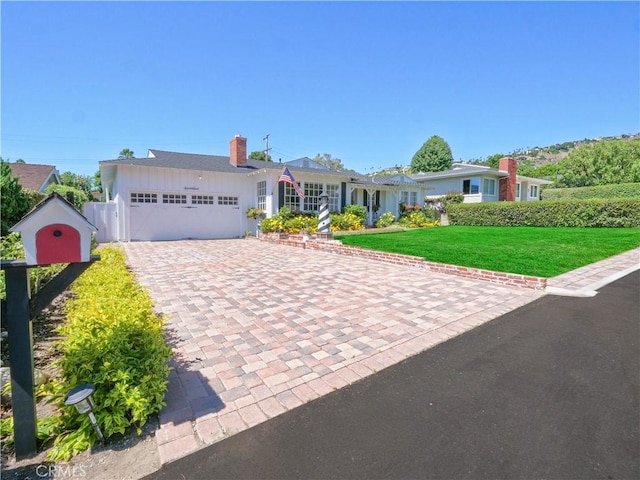 ranch-style house with a garage and a front yard