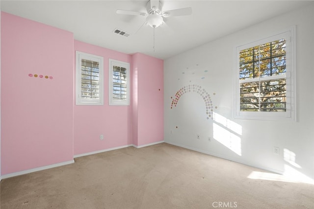 carpeted empty room featuring ceiling fan