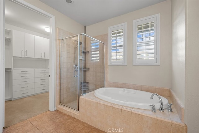 bathroom with tile patterned floors and separate shower and tub