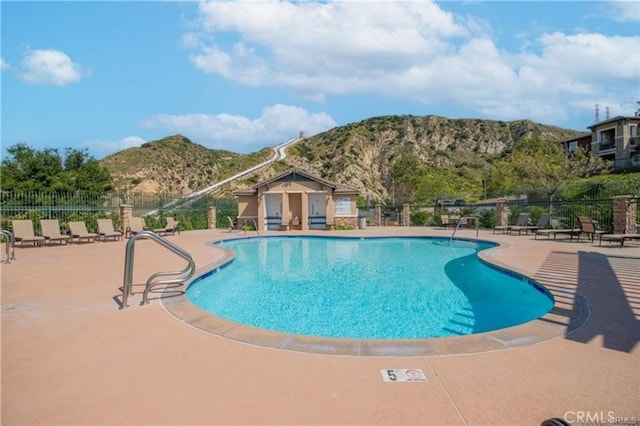 view of pool with a mountain view and a patio area