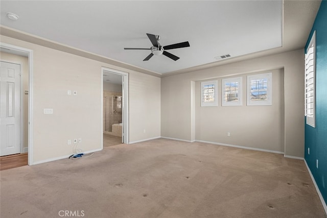 empty room featuring ceiling fan and light colored carpet