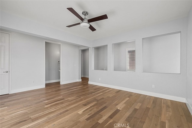 unfurnished room with hardwood / wood-style flooring and ceiling fan