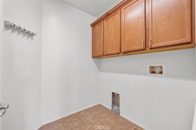 clothes washing area with hookup for a washing machine and cabinets