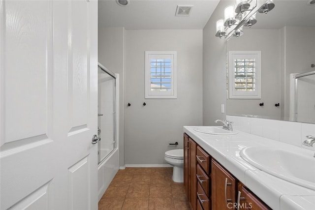 full bathroom featuring vanity, tile patterned floors, toilet, and a healthy amount of sunlight