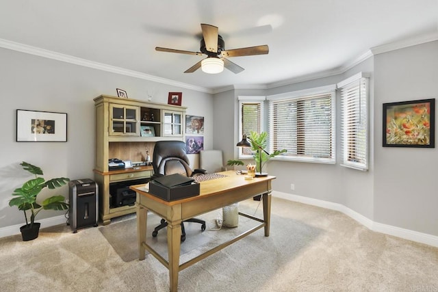 carpeted home office with crown molding and ceiling fan