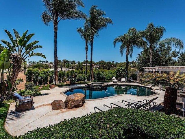 view of pool featuring an in ground hot tub and a patio area