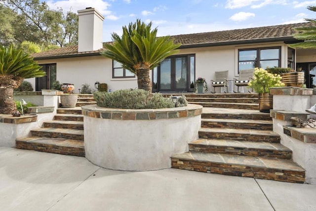 rear view of house featuring french doors