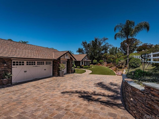 view of front of property with a garage and a front yard