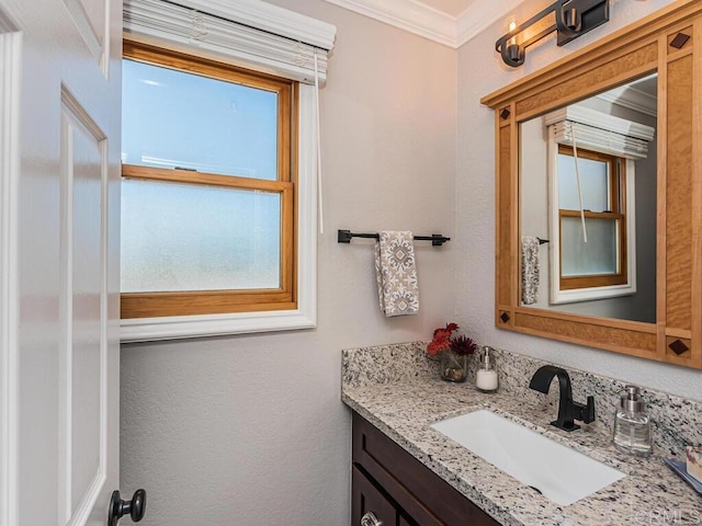 bathroom featuring crown molding and vanity